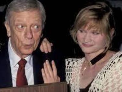 Frances Yarborough has her hands on Don Knotts shoulder as she is looking at him.